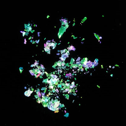 emerald green to ruby red flake pigment effect on black background