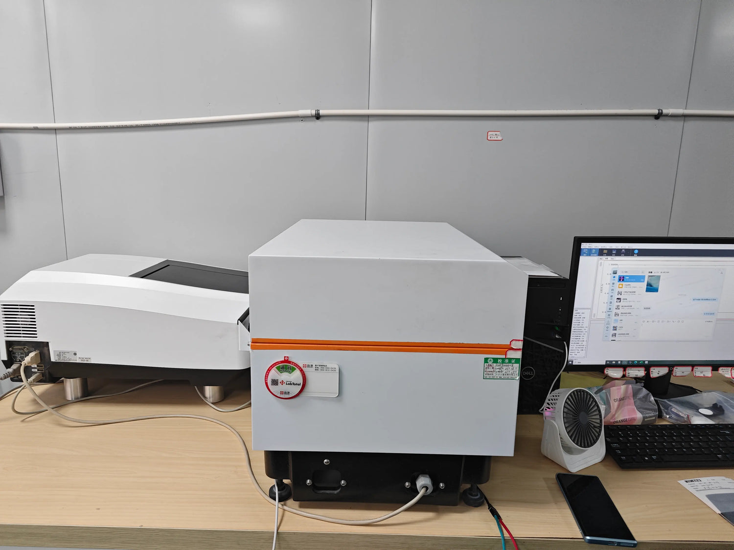 Optical pigment R&D and quality control laboratory equipped with spectrophotometer and particle size analysis instruments for performance testing.